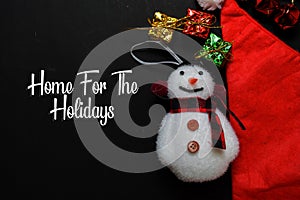 Home For The Holidays text isolated on black backgroud. Frame of Christmas Decoration