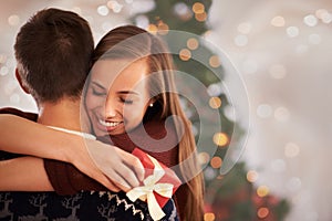 Home, hug and couple with love, Christmas and festive season with marriage and holiday. Apartment, embrace or man with