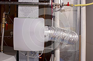A home humidifier attached to the return duct with a bypass connection to the supply hot air duct