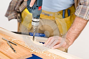 Home improvement - handyman drilling wood photo