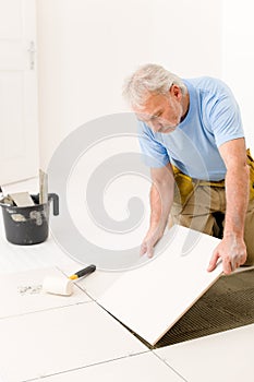 Home improvement - handyman laying ceramic tile