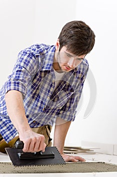 Home improvement - handyman laying tile