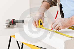 Home improvement - handyman measure porous brick photo