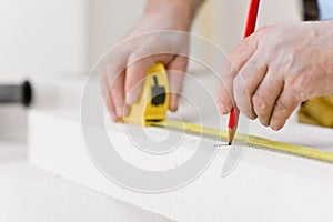 Home improvement - handyman measure porous brick photo