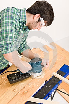 Home improvement - handyman sanding wooden floor