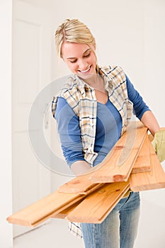 Home improvement - handywoman carry wooden plank photo