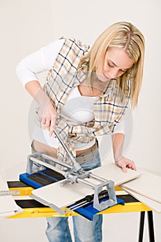 Home improvement - handywoman cutting tile photo