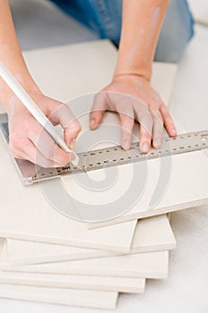 Home improvement - handywoman measuring tile photo