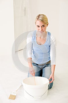 Home improvement - handywoman mixing paint photo