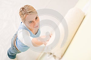 Home improvement - handywoman painting wall photo
