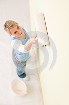 Home improvement - handywoman painting wall photo