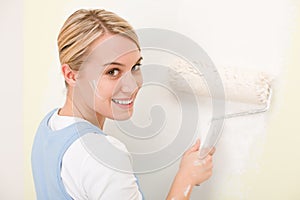 Home improvement - handywoman painting wall photo