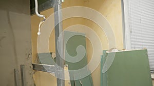 home improvement. a man dismantles a drywall arch in a room