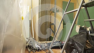 home improvement. a man dismantles a drywall arch in a room