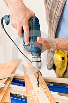 Home improvement - man drilling wood