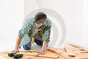 Home improvement - man installing wooden floor