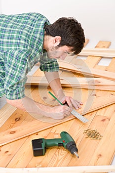 Home improvement - man installing wooden floor