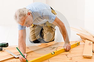 Home improvement - man installing wooden floor