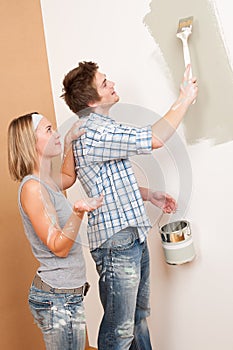 Home improvement Man painting wall with paintbrush