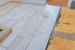 Home improvement placing ceramic tile on floor