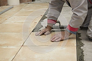 Home improvement, renovation - construction worker tiler is tiling