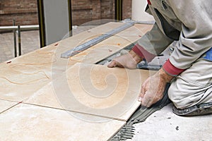 Home improvement, renovation - construction worker tiler is tiling