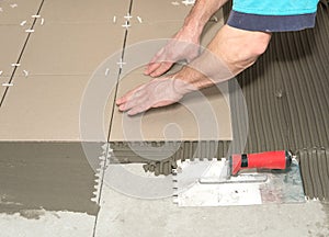 Home improvement, renovation. Construction worker is tiling, ceramic tile.