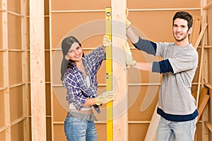 Home improvement smiling couple with spirit level