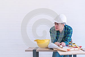 Home improvement worker working on workshop table with tools and instrument