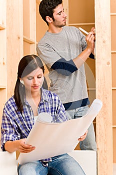 Home improvement young couple with blueprints