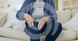 Home, injury and senior woman with knee pain, massage and inflammation in a living room. Pensioner, old person and