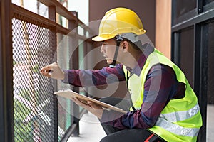 Home inspection consultancy. Inspector checking material of balcony and looking for fracture