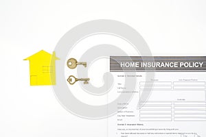 Home insurance concept with home cardboard and key