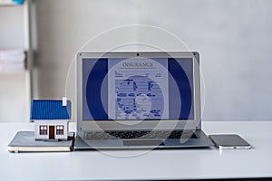 Home insurance concept, laptop mockup on table, real estate loan