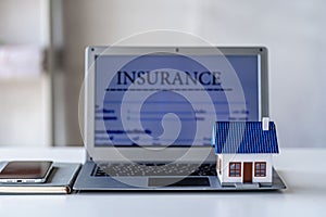 Home insurance concept, laptop mockup on table, real estate loan