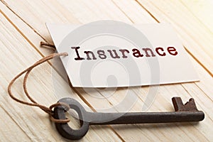 home insurance concept - old key with tag