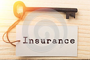 home insurance concept - old key with tag