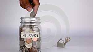 Home Insurance Glass Jar Money Saving Concept