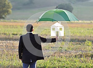 Home insurance protection concept, businessman with umbrella