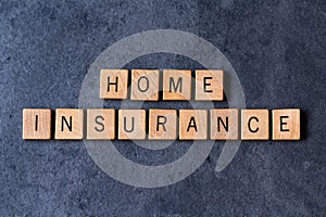 `Home Insurance` spelled out in wooden letter tiles photo