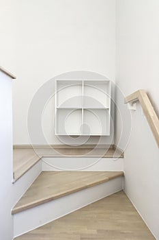Home interior image of minimal design winder staircase with small cabinet for modern small space residence.