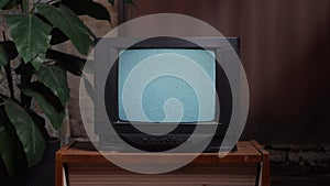 Home interior old television set. Bad television signal noise. 90s retro tv screen static noise. Living room old tv set