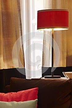 Home interior with red lamp and window with curtains
