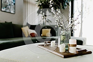 Home interior. Relaxing candles. Apple tree color has flown. Blurred background