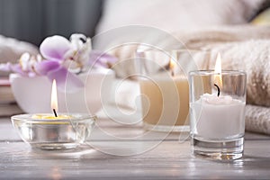 Home interior. Still life with detailes. Flower is vase, candles, on white wooden table, the concept of coziness