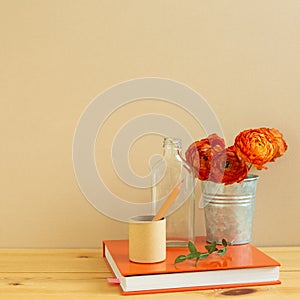 Home interior. Work and study place. note book, pencil with floral decoration on wooden desk with beige background