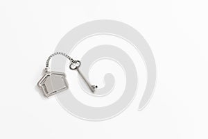 Home key with house keychain on white background