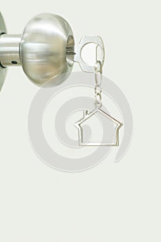 Home key with house keyring in keyhole, property concept, copy space