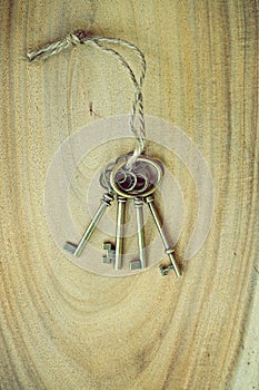 Home key with house keyring on wood background