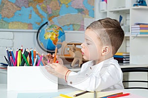 Home kids learning, home school. Kid in class on background of blackboard. Education. Home schooler. Cute little boy